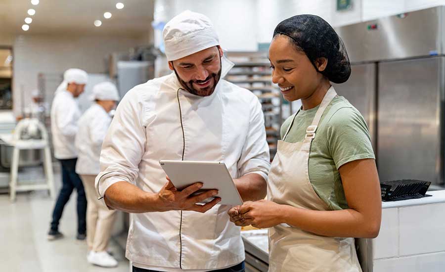 two chefs reviewing a checklist