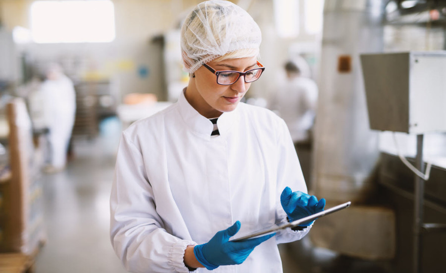 woman working in a lab using an ipad