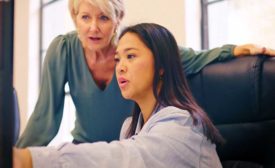 two women discussing something they see on the computer