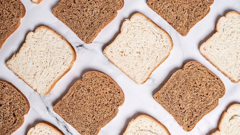 slices of white and brown bread laid out on table