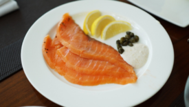 smoked salmon on a plate with garnishes