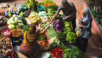 people trading produce at a traditional market