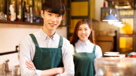 two smiling baristas